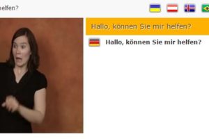 Screenshot von Spread Signs: Frau gebärdet "Hallo, können Sie mir helfen?"
